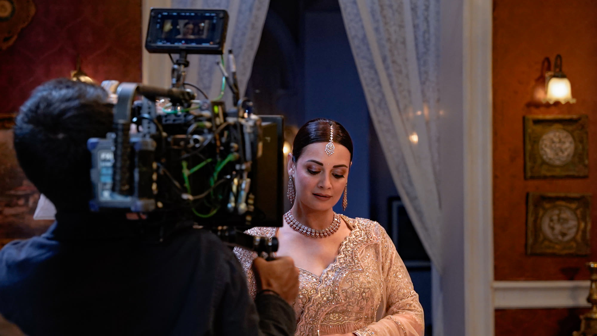 Crew setting up lighting and camera on an interior film set